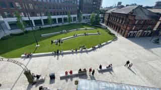 New terraced seating, seating wall and seating benches amongst lawned area in Aire Park.