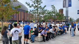 Everton fans sat on a seating plinth in the fan plaza