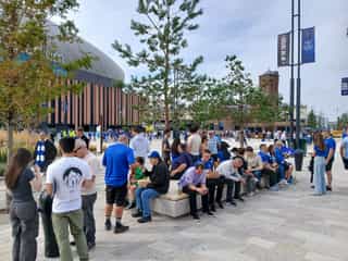 Everton fans sat on a seating plinth in the fan plaza